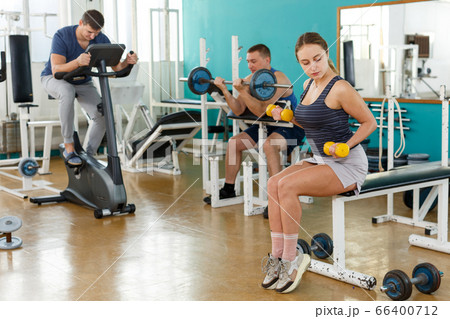 Sporty girl with dumbbells foreground 66400712