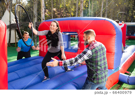 Woman playing tug of war with hoop Woman playing tug of war with hoop 66400979