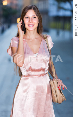 woman looking to phone in hands and chatting in city woman looking to phone in hands and chatting in city 66401176