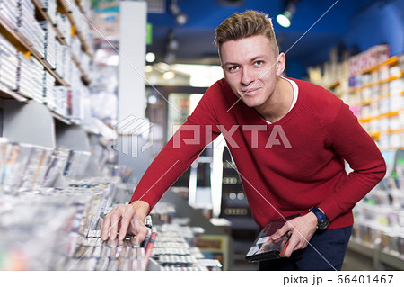 Glad surprised man in search of movies 66401467