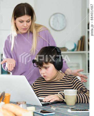 Upset mother arguing with son who plaing video games Upset mother arguing with son who plaing video games 66401487