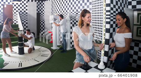 Friends which divided into groups are trying to get out of the escape room Friends which divided into groups are trying to get out of the escape room 66401908
