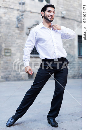 Passionate man dancing alone outdoors 66402473