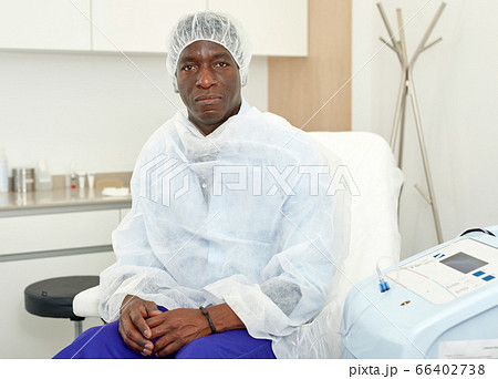 Man sitting in armchair before procedure in clinic of esthetic cosmetology Man sitting in armchair before procedure in clinic of esthetic cosmetology 66402738