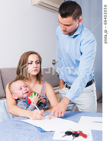 Gloomy female signing documents 66403059