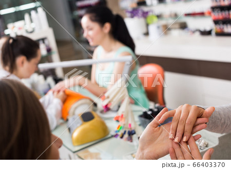 Woman hands receiving manicure Woman hands receiving manicure 66403370