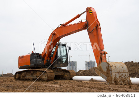 Excavator during earthworks at construction site Excavator during earthworks at construction site 66403911