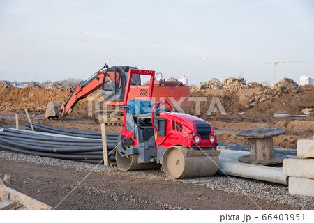 Road roller and excavator working at construction Road roller and excavator working at construction 66403951