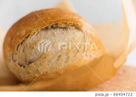 Fresh loaf of bread cooling on cutting board Fresh loaf of bread cooling on cutting board 66404722