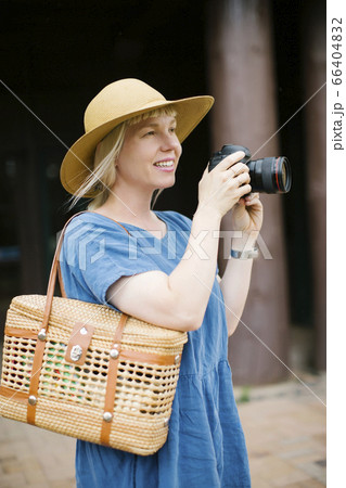 Woman holding digital camera Woman holding digital camera 66404832