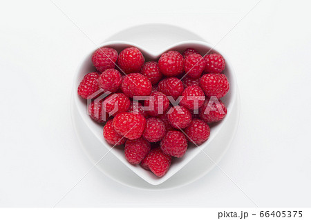 Raspberries in heart-shaped bowl 66405375