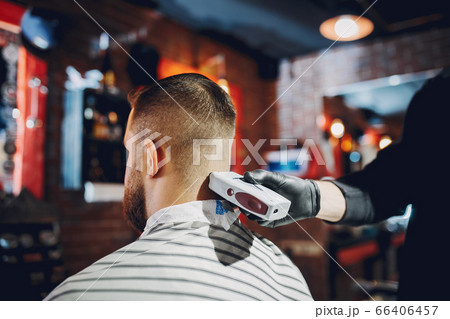 Stylish man sitting in a barbershop Stylish man sitting in a barbershop 66406457