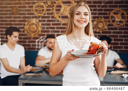 Cute friends in a cafe eatting a pizza Cute friends in a cafe eatting a pizza 66406487
