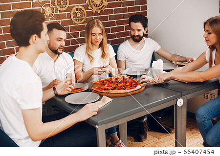 Cute friends in a cafe eatting a pizza 66407454