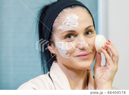 Woman using organic Konjac Cleansing Sponge for face Woman using organic Konjac Cleansing Sponge for face 66409578