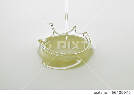 Dripping colorless oil on white background. 66409979