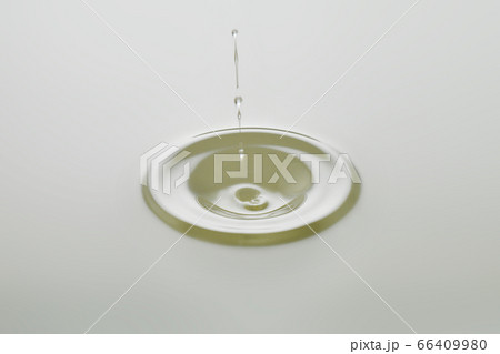 Dripping colorless oil on white background. Dripping colorless oil on white background. 66409980