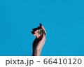 Woman holding golden bitcoin in her hand 66410120
