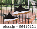 Black woman sneakers on a sportsground with sun 66410121