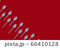 Plastic spoons on dark burgundy background pattern 66410128