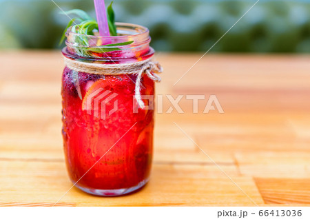 Lemonade or mojito cocktail with lemon and raspberry 66413036