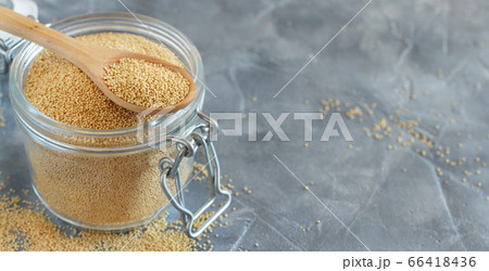 Jar of raw Amaranth seeds with a spoon Jar of raw Amaranth seeds with a spoon 66418436