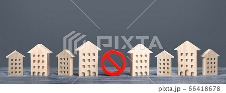 A red prohibition sign no stands among residential buildings. Restrictions ban on construction. Inaccessible expensive housing. Restriction building compaction. Underdeveloped infrastructure utilities 66418678