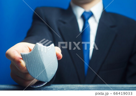 A man holds a protection shield in his hand. Safety, life and property insurance. Security personnel, maintaining law and order. Lawyer defends the rights and innocence. Protectionism, defense 66419033