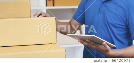 The shipping company checking parcels list before The shipping company checking parcels list before 66420972
