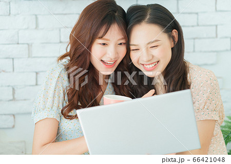 Two woman doing exercise at home Two woman doing exercise at home 66421048