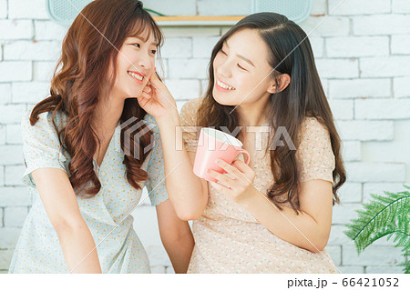 Two woman doing exercise at home 66421052