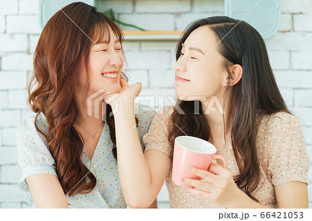 Two woman doing exercise at home 66421053
