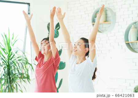 Two woman doing exercise at home Two woman doing exercise at home 66421063