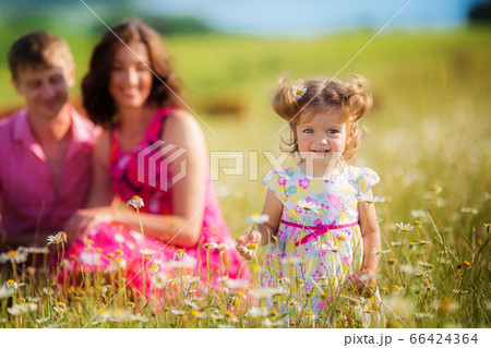 Happy young family with children having fun outdoors. Happy young family with children having fun outdoors. 66424364