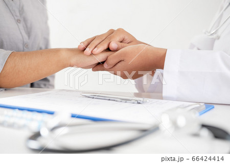 Doctor holding hands to encouragement and explained the health examination results to the patient 66424414