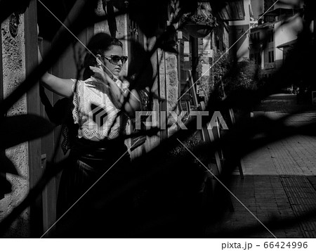 Woman standing near the stone building 66424996