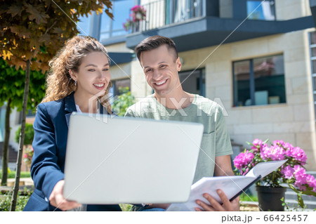 Female broker offering variants for apartment rent to the client Female broker offering variants for apartment rent to the client 66425457