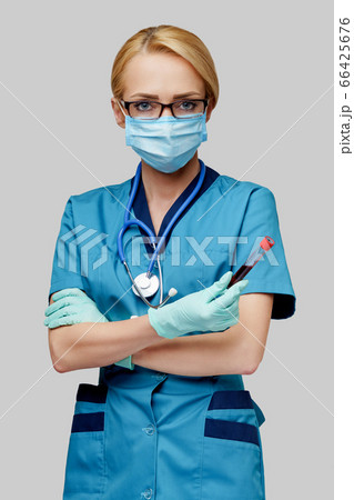 medical doctor nurse woman wearing protective mask and gloves - holding virus blood test tube 66425676