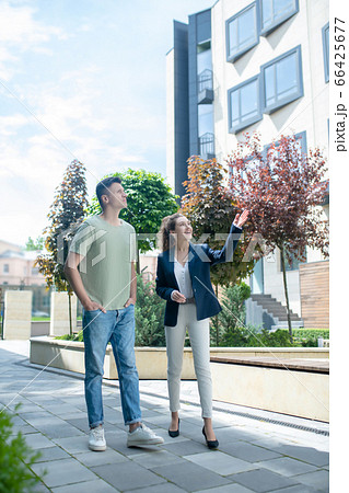 Elegant realtor offering possible variants to the customer searching for the apartment Elegant realtor offering possible variants to the customer searching for the apartment 66425677