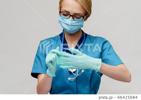 medical doctor nurse woman with stethoscope wearing protective mask and rubber or latex gloves medical doctor nurse woman with stethoscope wearing protective mask and rubber or latex gloves 66425684