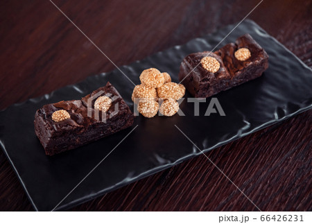 Chocolate brownies with sesame balls or Klepon, Kelepon, Onde Onde- traditional Southeast Asian rice cake balls. Asian modern dessert Chocolate brownies with sesame balls or Klepon, Kelepon, Onde Onde- traditional Southeast Asian rice cake balls. Asian modern dessert 66426231