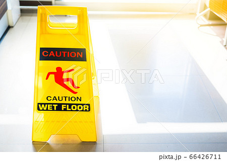 Sign showing warning of caution wet floor on wet Sign showing warning of caution wet floor on wet 66426711
