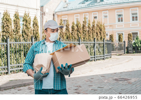 Courier in protective mask and medical gloves Courier in protective mask and medical gloves 66426955