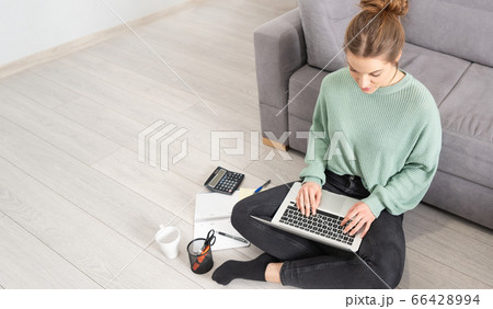 Young student learns at home on the floor 66428994