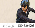 Asian motorcyclist is riding his motorcycle. 66430426