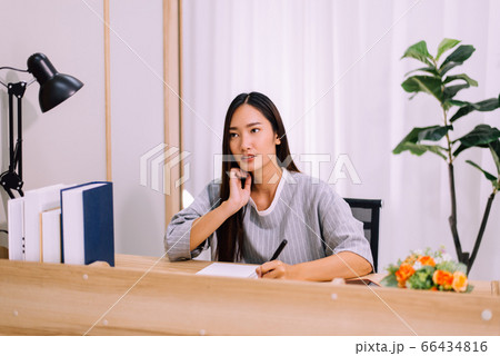 Beautiful young asian woman writing diary or story from home Beautiful young asian woman writing diary or story from home 66434816