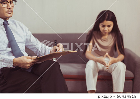 Professional psychologist talking with asian woman patient and writing notes,Therapist conducting a consultation and counseling to women Professional psychologist talking with asian woman patient and writing notes,Therapist conducting a consultation and counseling to women 66434818