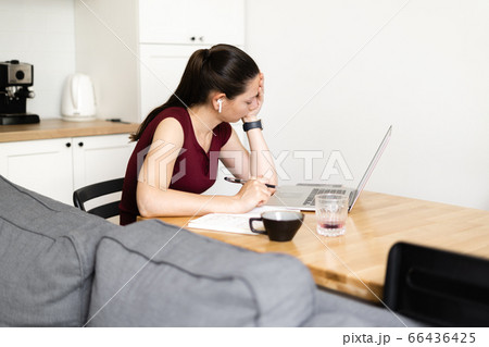 Millennial woman works from home. Exhausted girl, stress, overwork concept. E-learning 66436425