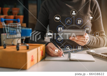 Shipping shopping online ,woman start up small business owner writing address on cardboard box at workplace. 66438622