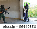 Soldier is rescuing Asian hostage. 66440358
